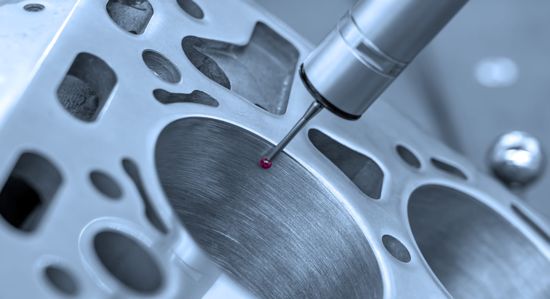 Measurement and control of the dimensions of a metal engine block part using a probe stylus ball tip of multi-axis coordinate measuring machine.